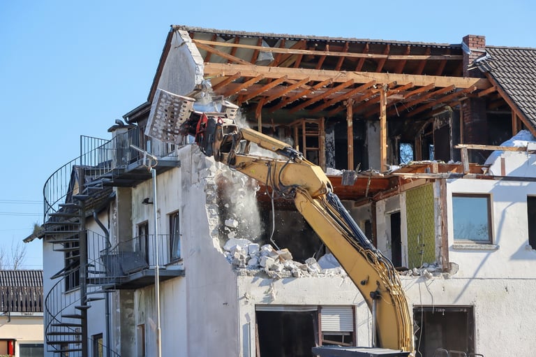 Excavator in demolition of residential home building. High quality photo