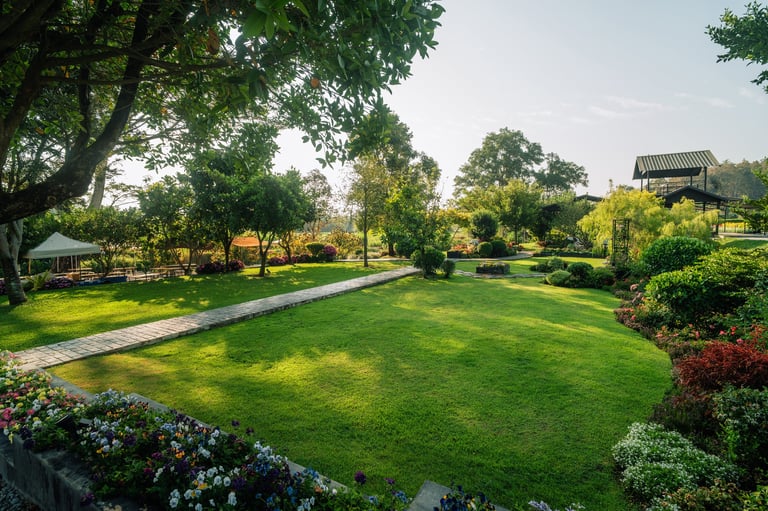 Beautiful landscaped garden with curved stone pathway through green lawn